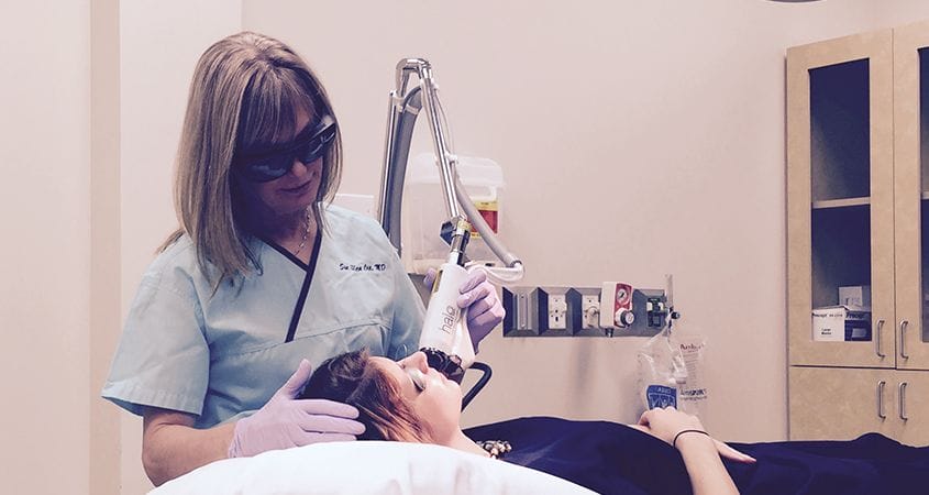 Dr. Cox performing a Laser treatment on patient at Aesthetic Solutions in Chapel Hill, NC